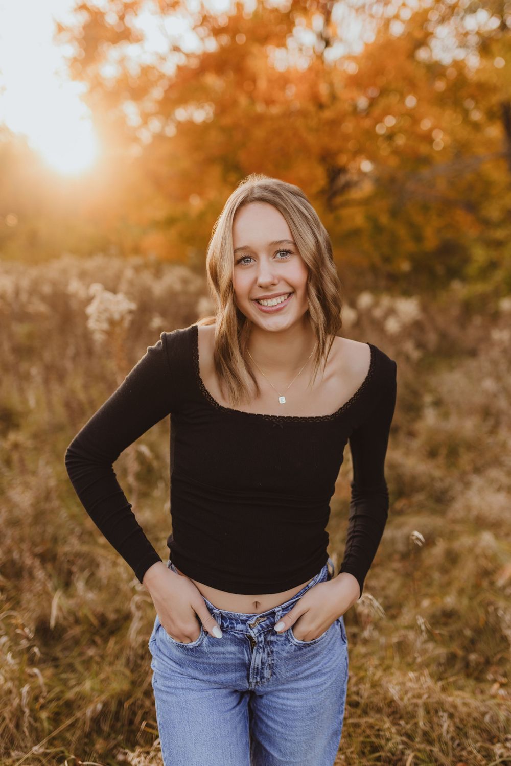 Casual outdoor portraits in autumn field with golden light and natural poses.