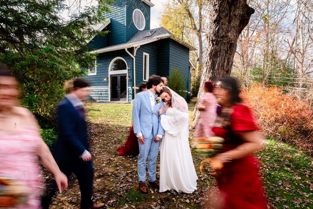 A series of motion blur photos showing people in formal attire moving through an autumn garden setting.