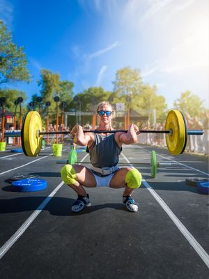 Sequence of weightlifting photos showing proper form for a barbell front squat exercise in an outdoor parking lot.