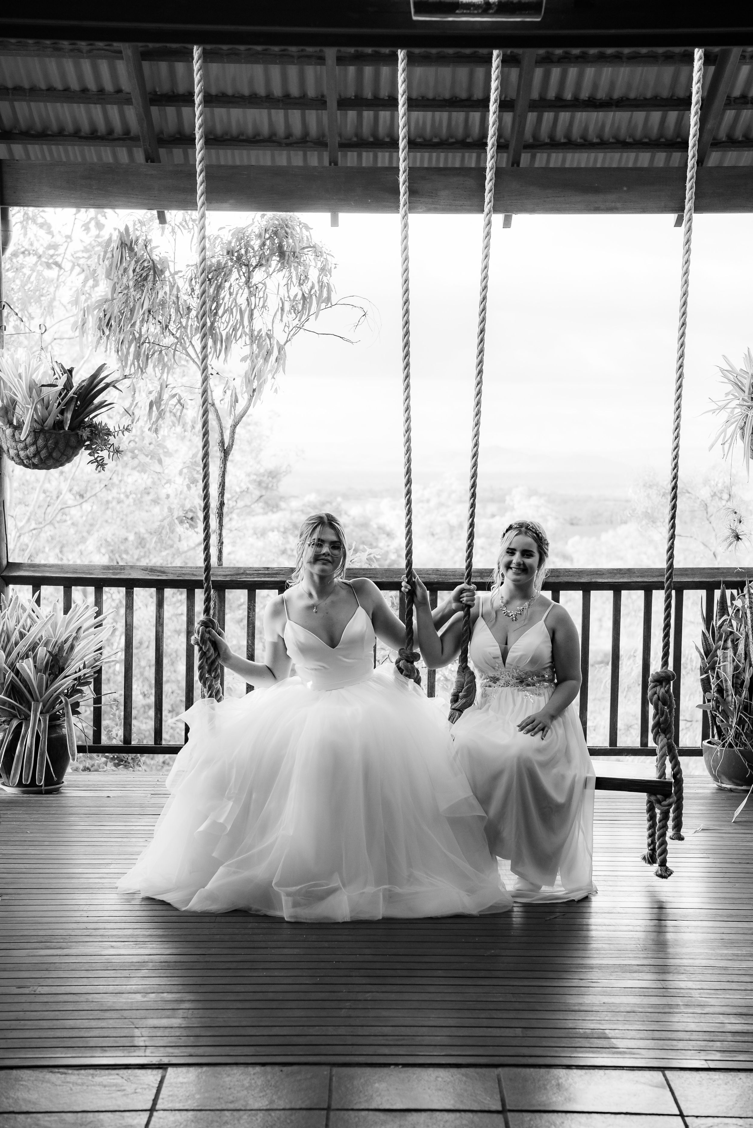 Group photos on covered deck with light filtering through leaves and palm trees.