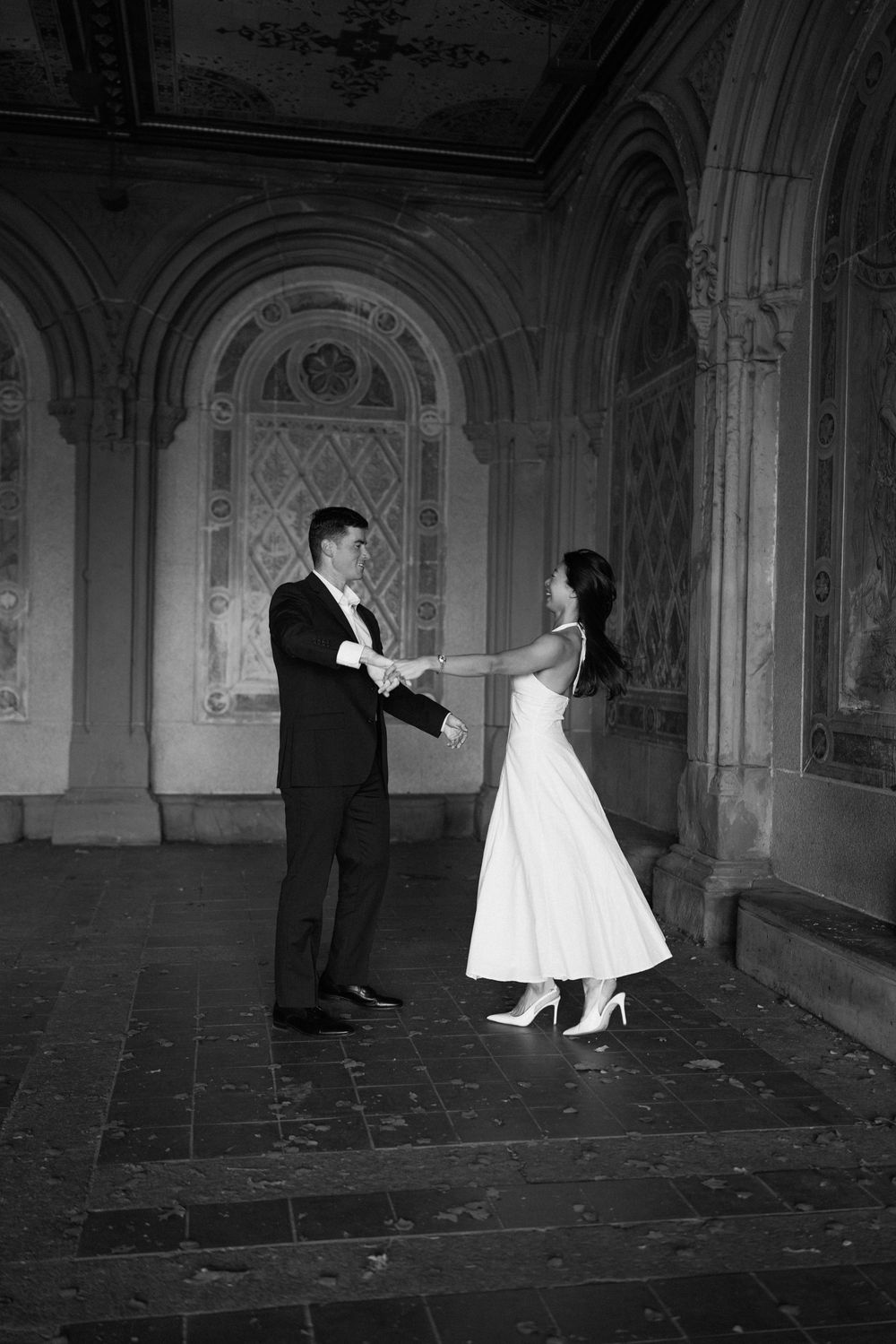 Artistic black and white sequence of a couple dancing in a Gothic corridor.