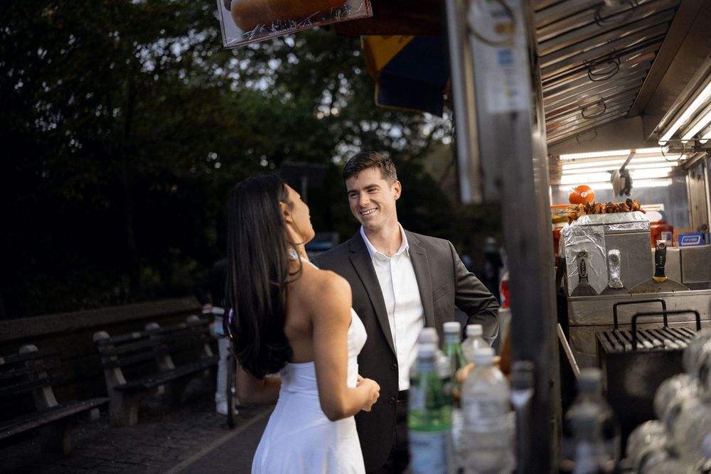 A couple shares a romantic moment in a park setting.
