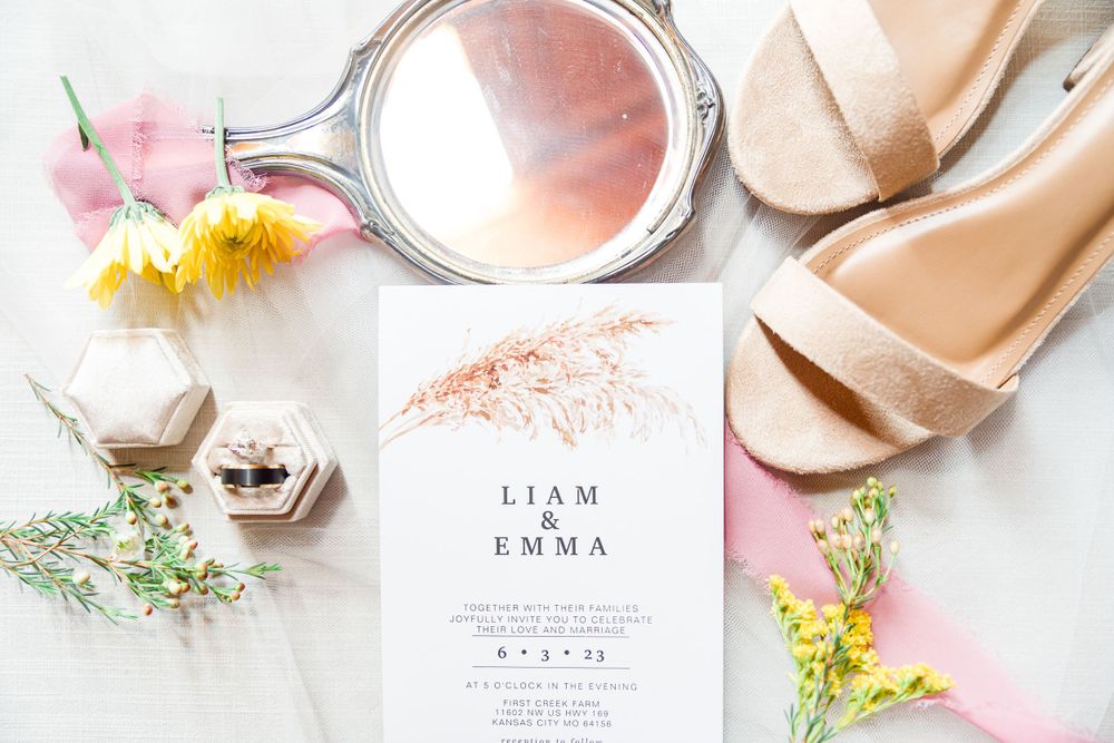 Wedding invitation with pink flowers, mirror, and nude shoes styled on an off-white background by Stephanie Coulter Photography