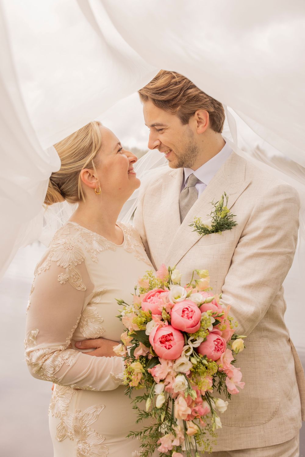 Four sequential wedding photos show a romantic couple posing with pink floral bouquet against white backdrop.
