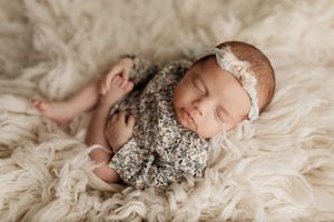 Sweet newborn baby photos with vintage-inspired lace and floral accessories on cream backgrounds.