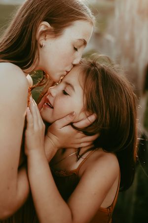 A tender romantic moment captured in warm lighting as two people share an intimate kiss.
