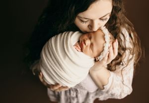 Artistic black and white portraits showing tender family moments in moody lighting.