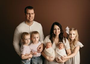 Family portrait progression showing growth from newborn twins to family of five in warm brown tones.