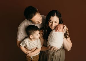 A couple in warm brown tones shares intimate moments in a series of romantic lifestyle portraits.