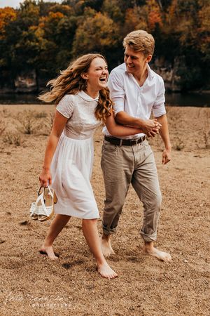 Couple running in sand, Cedar Rapids, IA