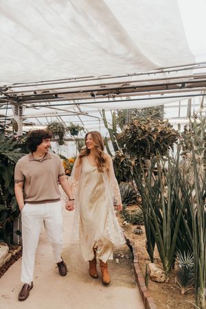 couple walking in greenhouse