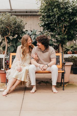couple sitting in greenhouse