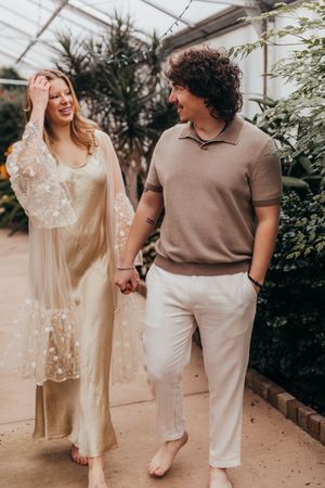 couple walking in greenhouse