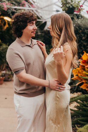 couple hugging in greenhouse