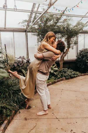 couple hugging in greenhouse