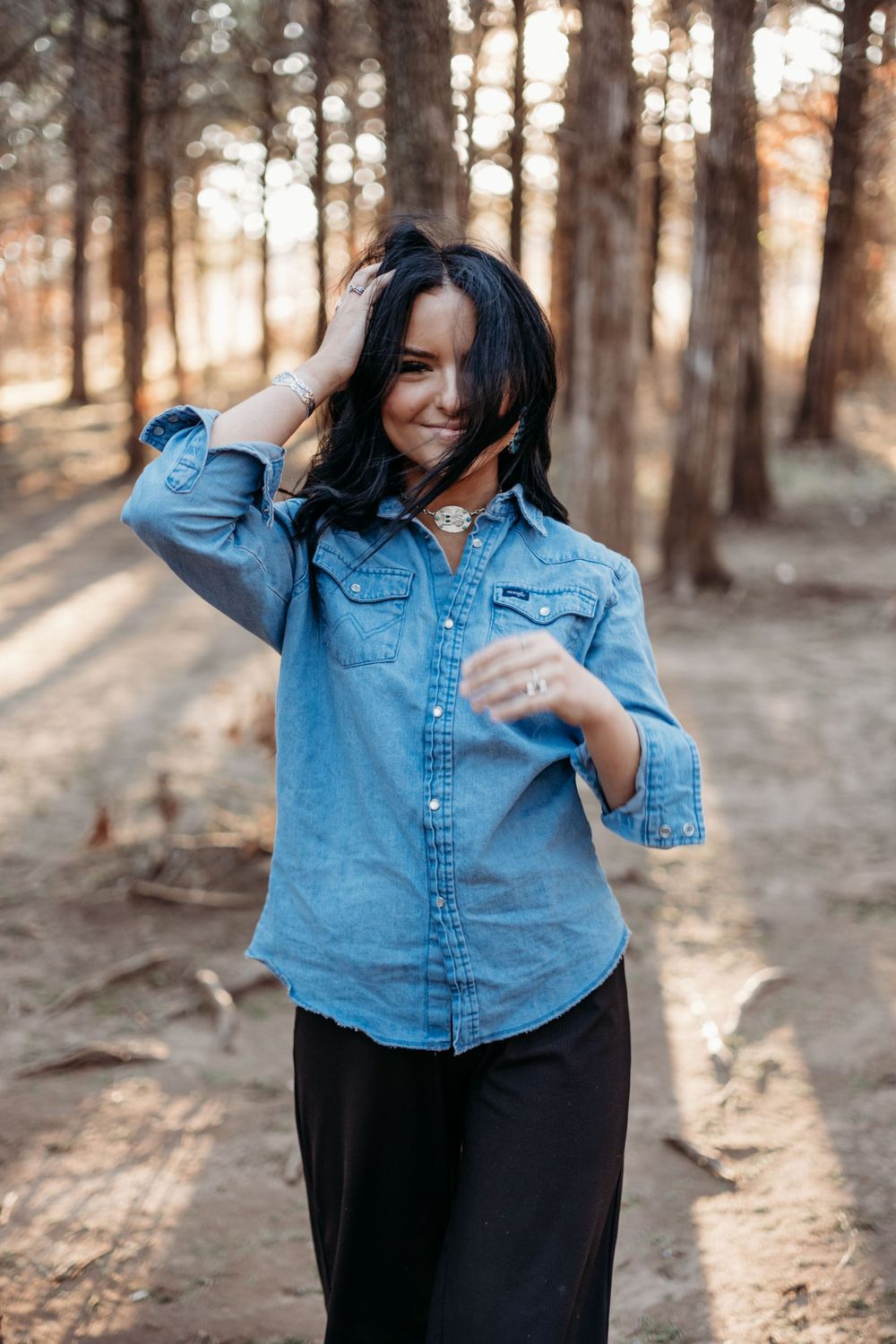 Casual fashion photos in a denim jacket against a sunlit forest backdrop.