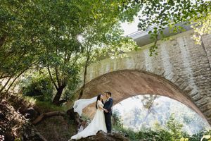 A collection of wedding photographs showing a couple in romantic outdoor settings under stone arches and bridges.
