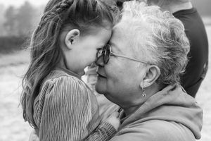 A heartwarming black and white photo series showing tender moments between a young child and elderly person.