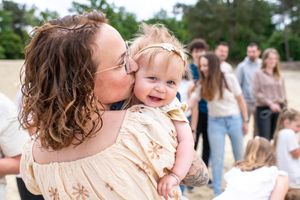 Candid moments of joy and laughter captured during an outdoor family photoshoot.