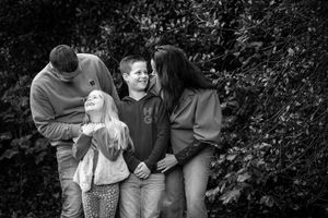 Black and white candid moments of laughter and connection in a garden setting.