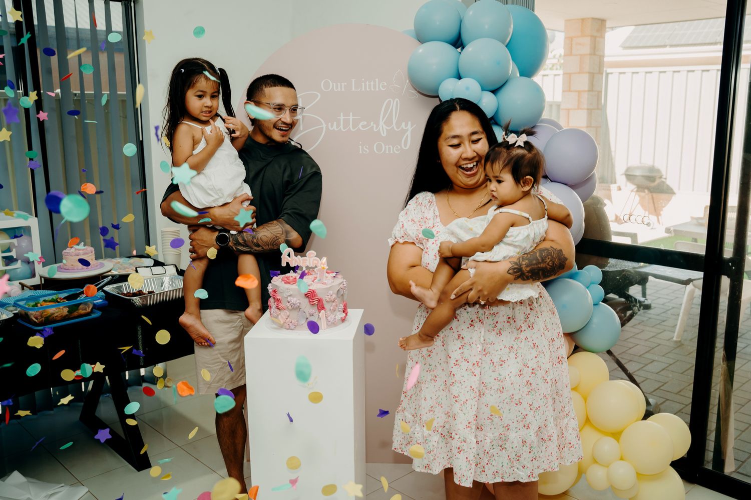 Baby celebration with blue and yellow balloon decorations and confetti.