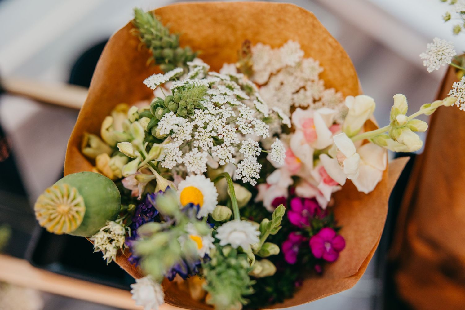 Colorful floral arrangement featuring wildflowers and baby's breath in warm sunlight.