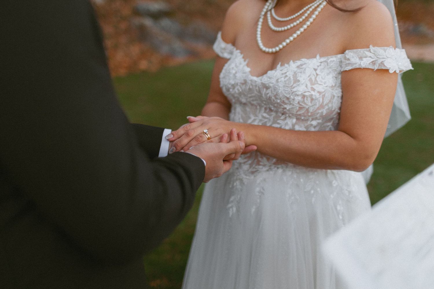 Black and white photo of a couple embracing during their first dance at an elegant wedding reception.