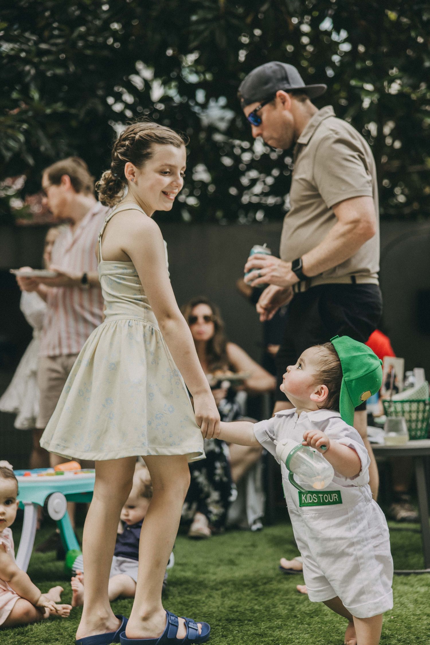 A split sequence photo of two people dancing together on grass at an outdoor gathering, showing fluid movement.