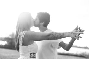 Romantic couple embraces in a dramatic black and white photo series showing tender moments together.