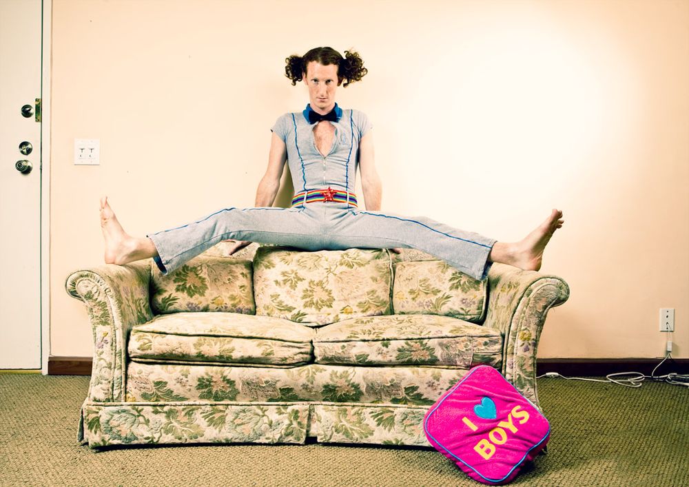 A floral print couch appears in multiple positions across a photo collage with a bright pink heart pillow.