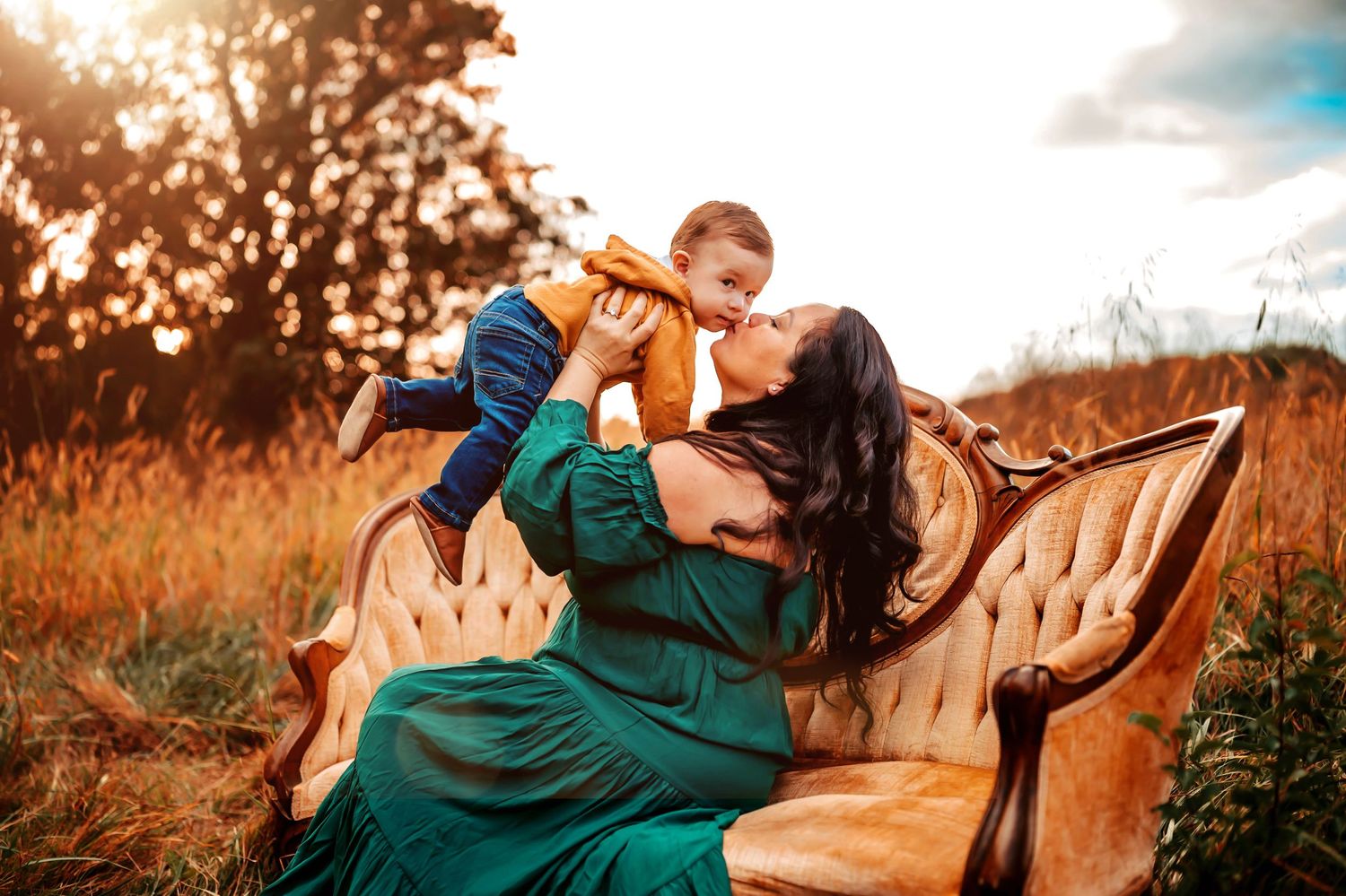 Couple sits on blanket surrounded by towering sunflowers during autumn photoshoot.
