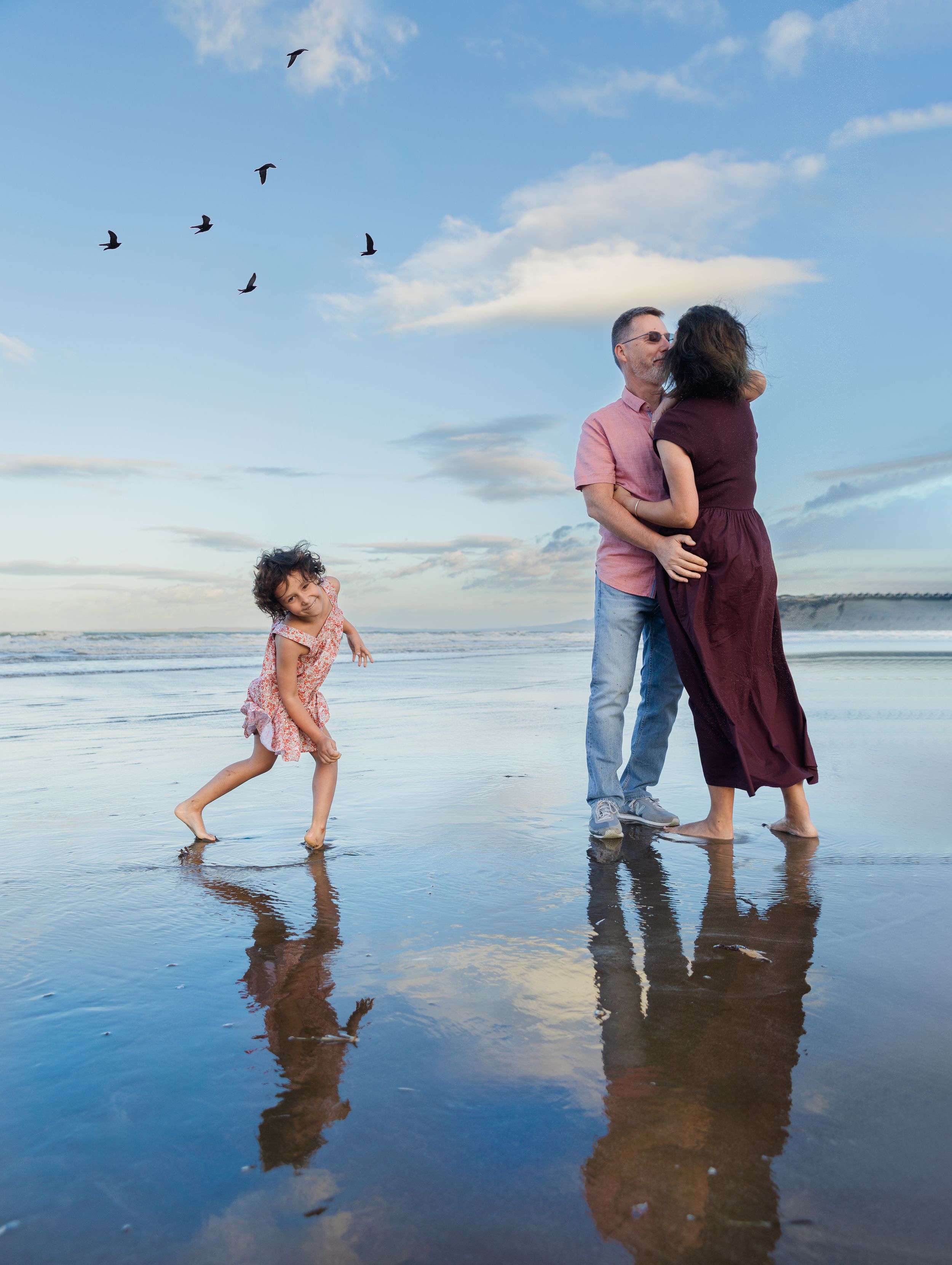 Family of three in a green outdoor setting.