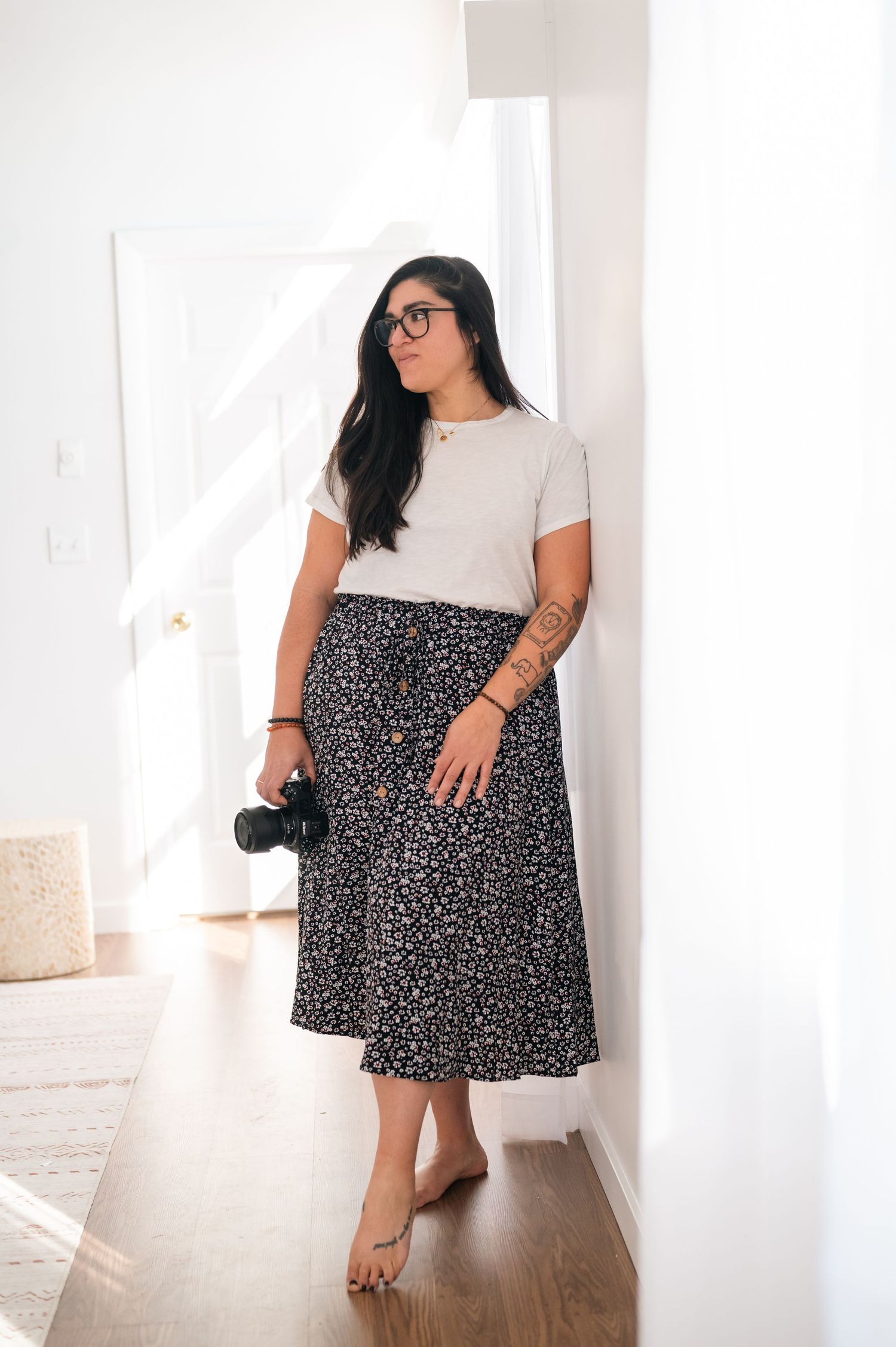 Fashion shots of a woman modeling a black and white polka dot skirt in different poses.