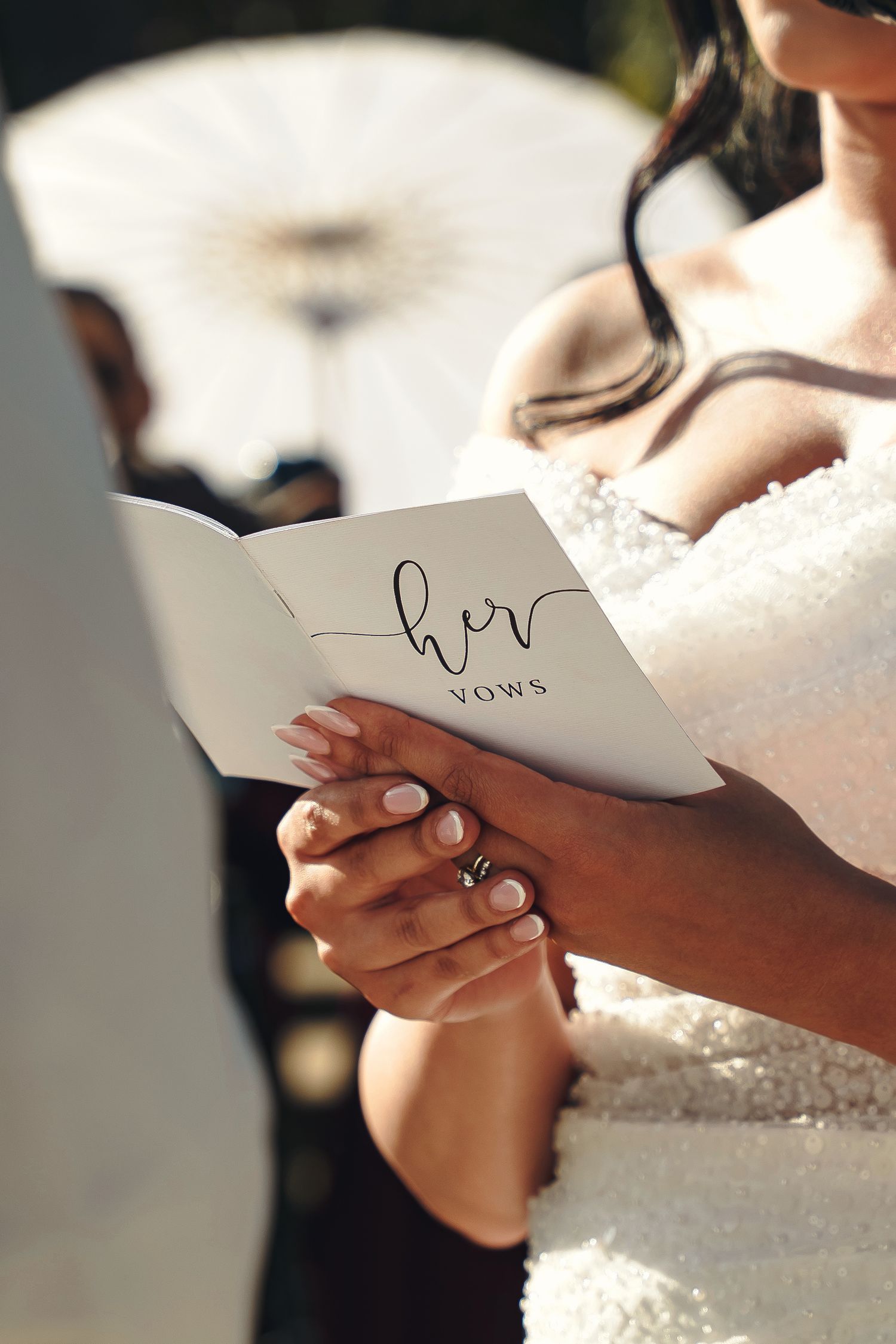 Wedding couple poses outdoors among trees with artistic motion blur effect.