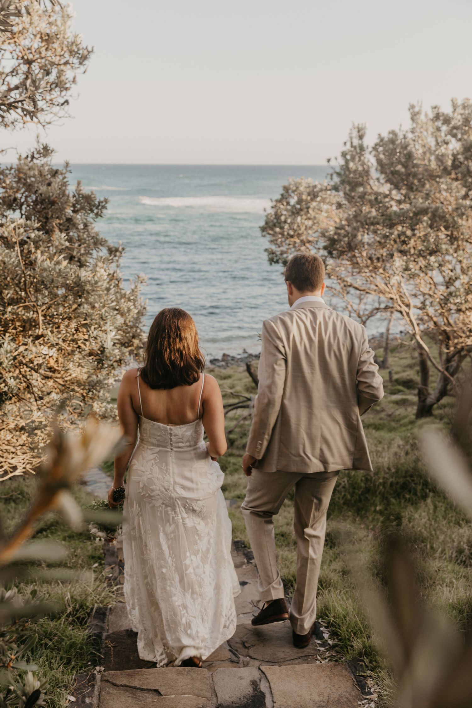 A candid moment shared between a bride and her husband captured by Byron Bay wedding photographer, Celia Galpin