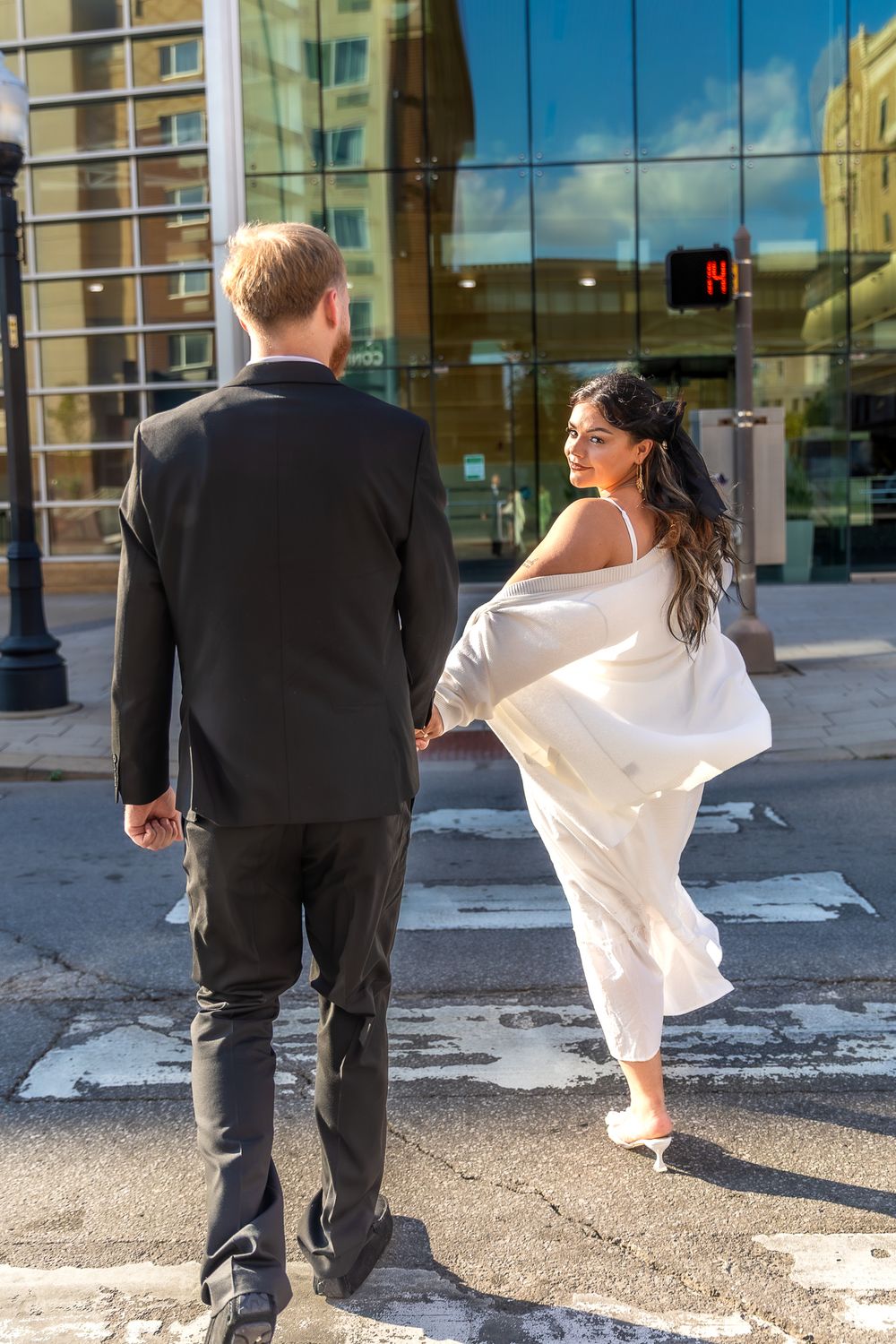 A bride twirls her white dress across five sequential photos showing movement and dance on a paved plaza.