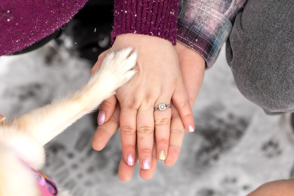 Close-up sequence showing hands gently pressing and kneading soft pink clay or dough material.