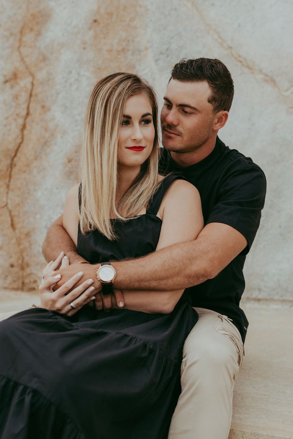 a couple enjoying their shoot with a granite backdrop, Namibia