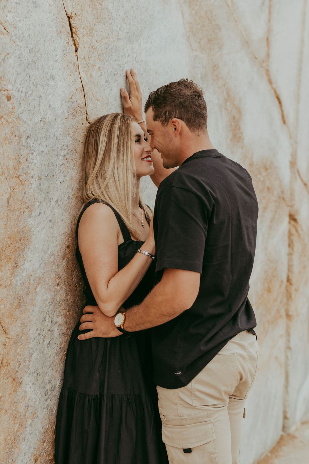 a couple enjoying their shoot with a granite backdrop, Namibia