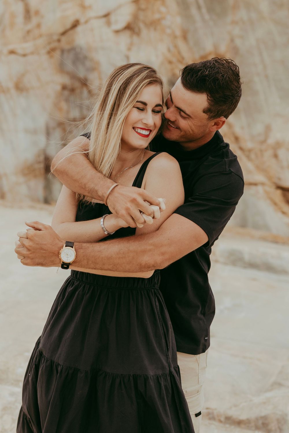 a couple enjoying their shoot with a granite backdrop, Namibia