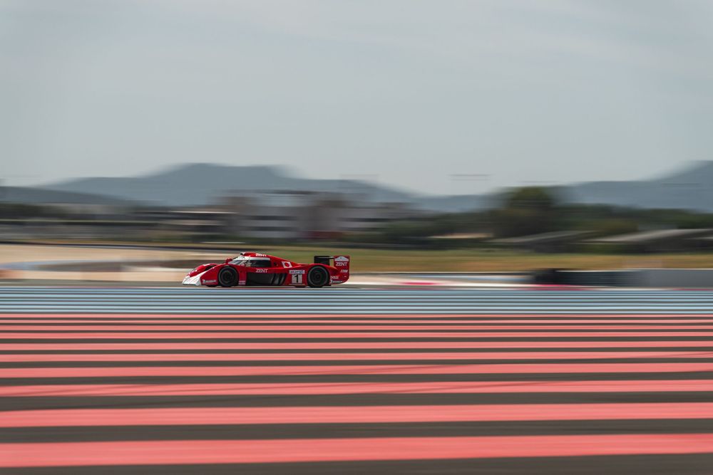 Red Ferrari racing at speed on circuit during Richard Mille trackday — luxury motorsport event photography — Paul Brechu