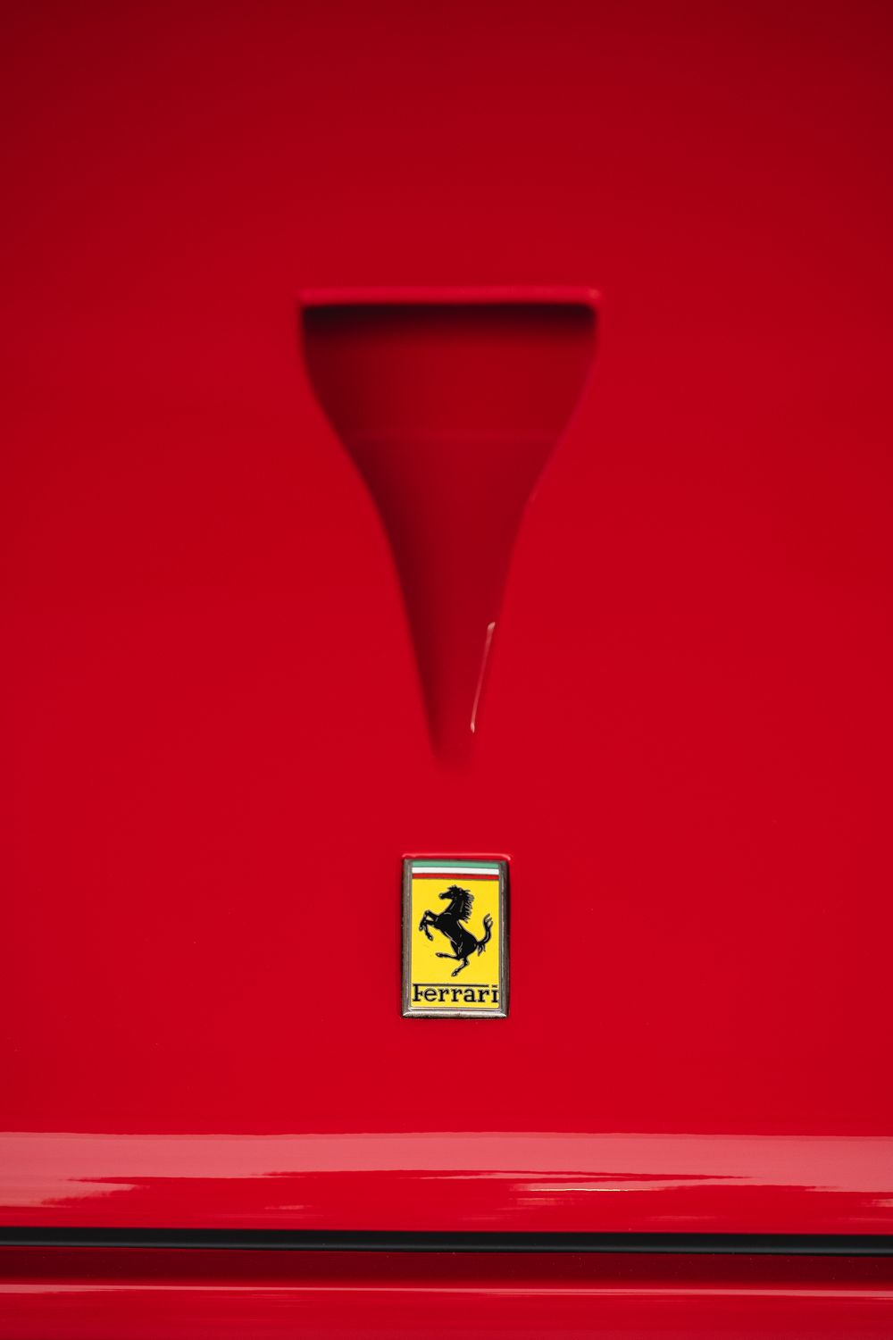 Ferrari prancing horse badge close-up on a red supercar at Richard Mille trackday — luxury brand event photography — Paul Brechu
