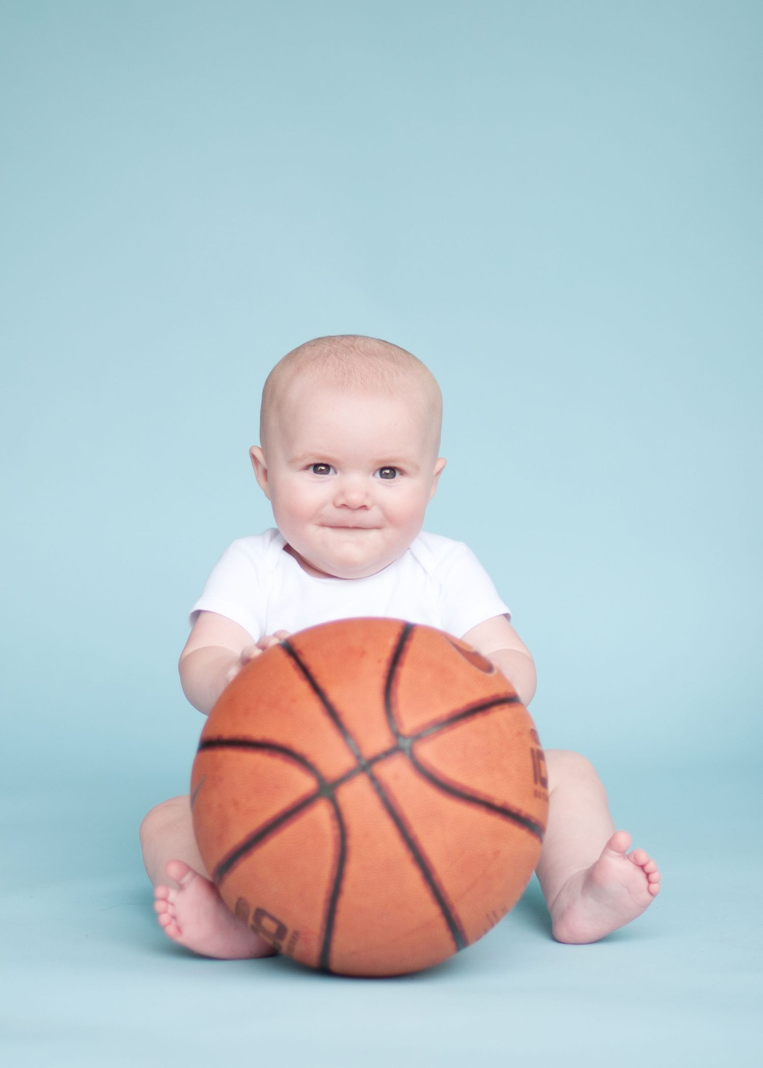 toddler holding basketball