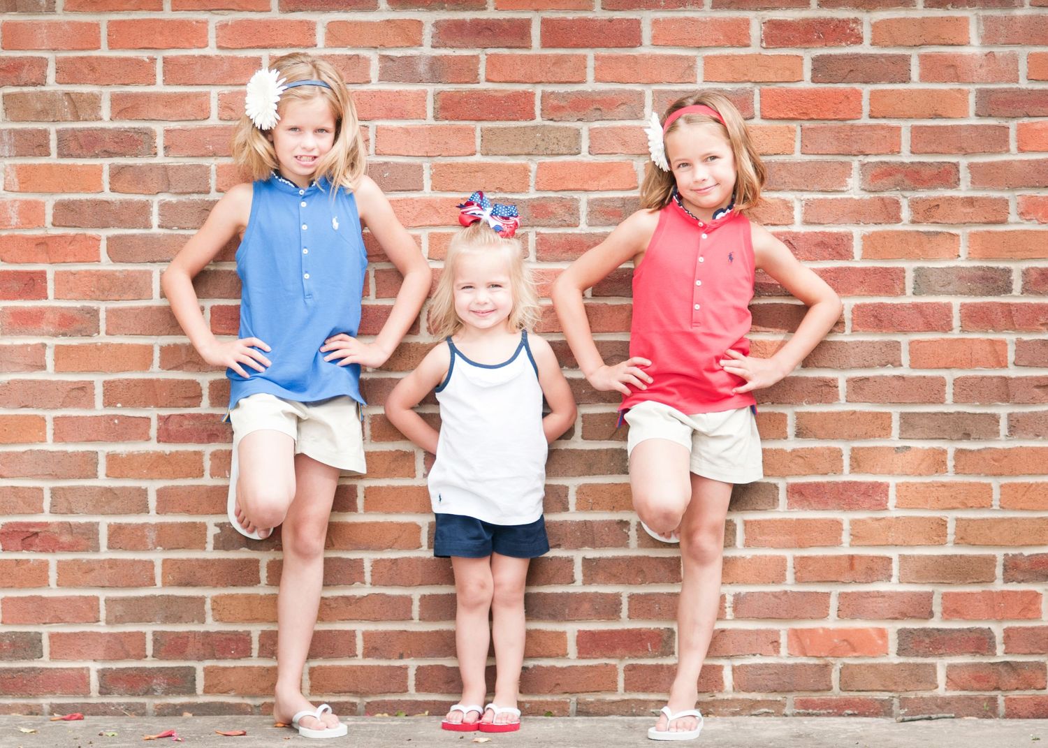 3 sisters against a brick wall