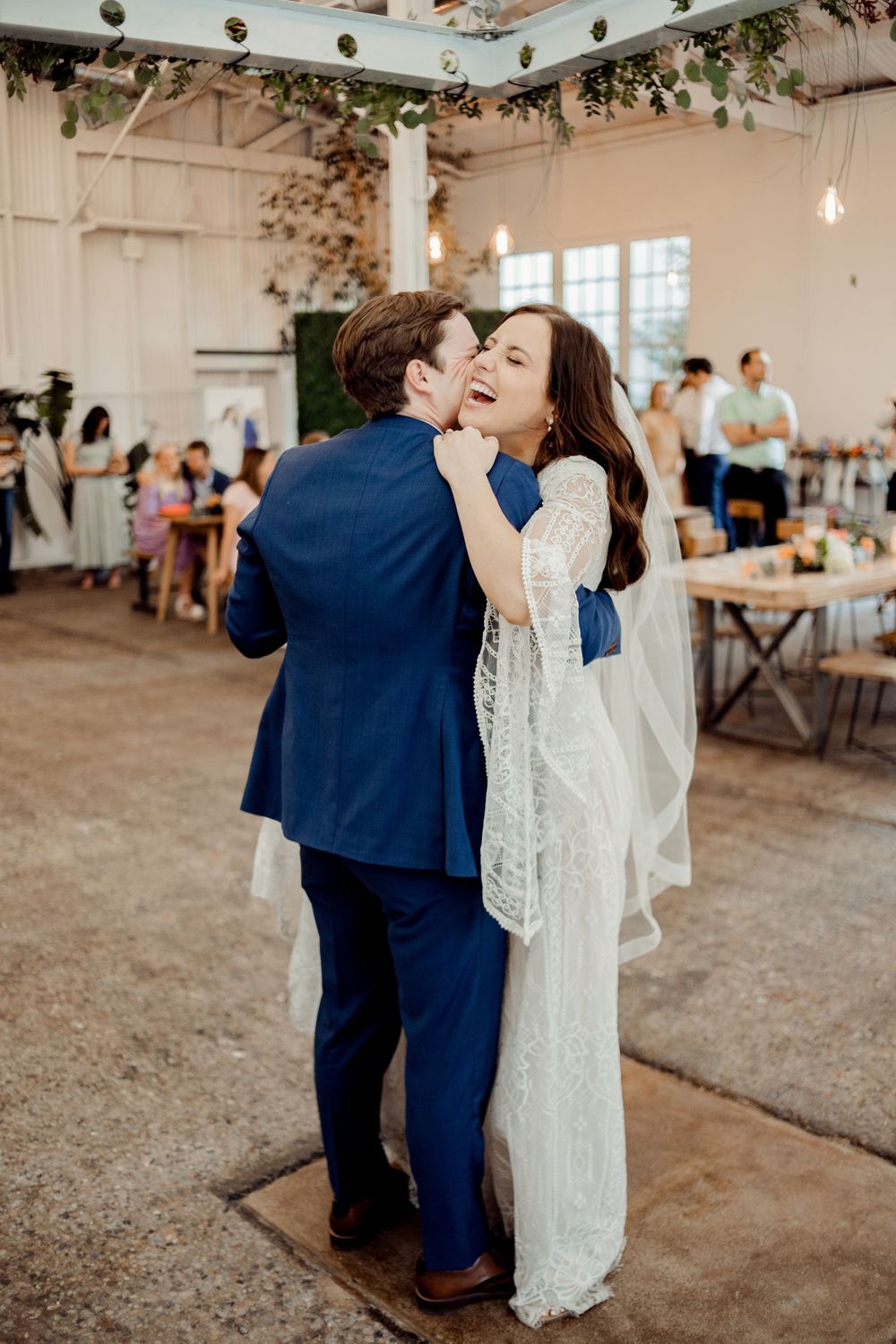 bride laughing during first dance at missouri wedding reception
