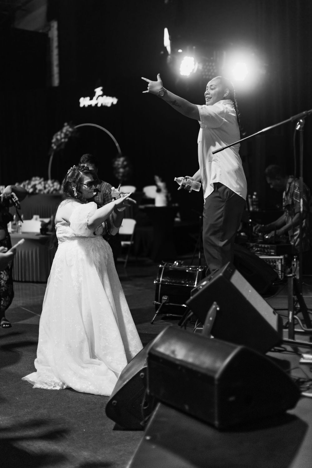 fun couple dancing and singing on stage at wedding reception photographed by missouri photographer