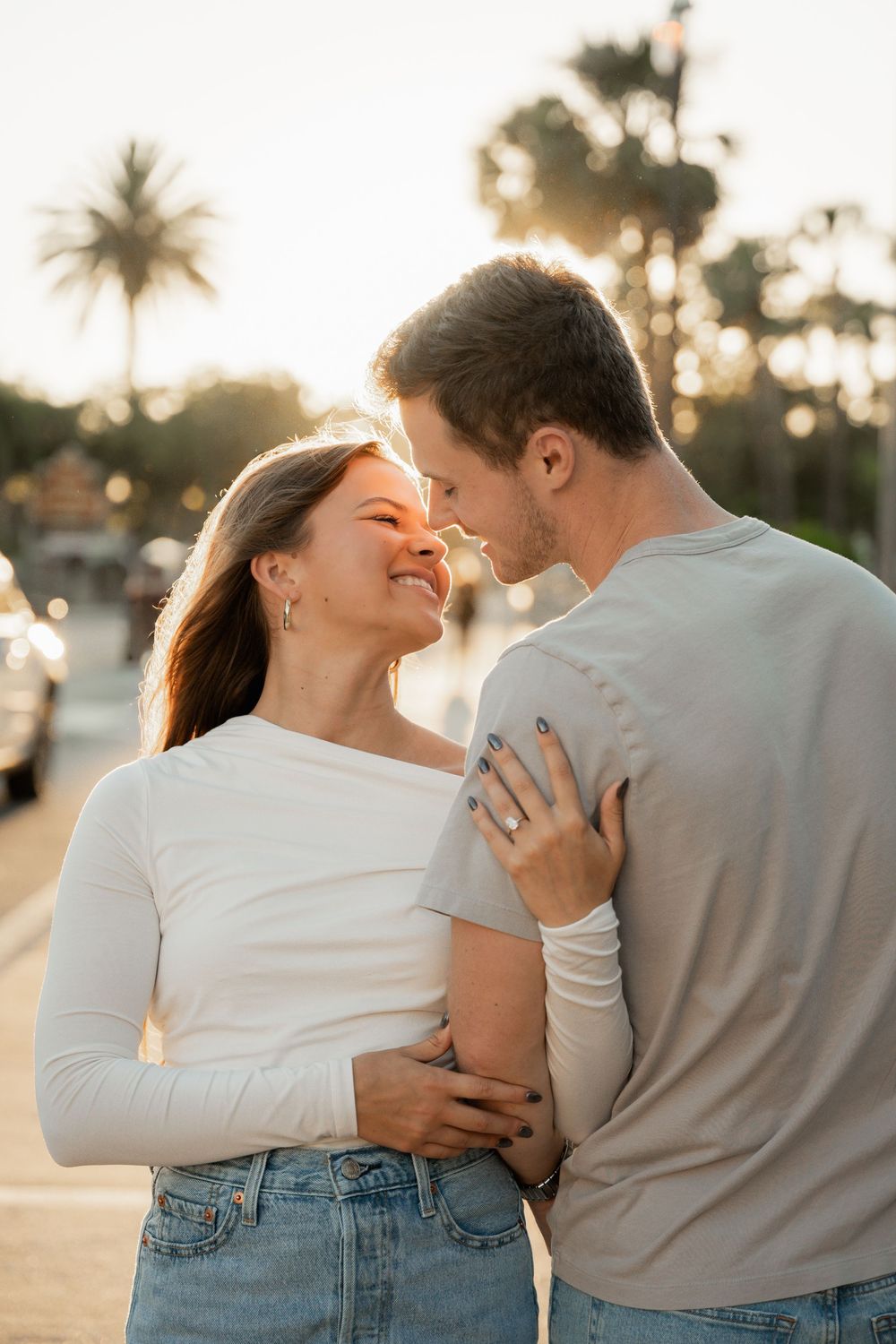 Expecting couple walking the shoreline at golden hour