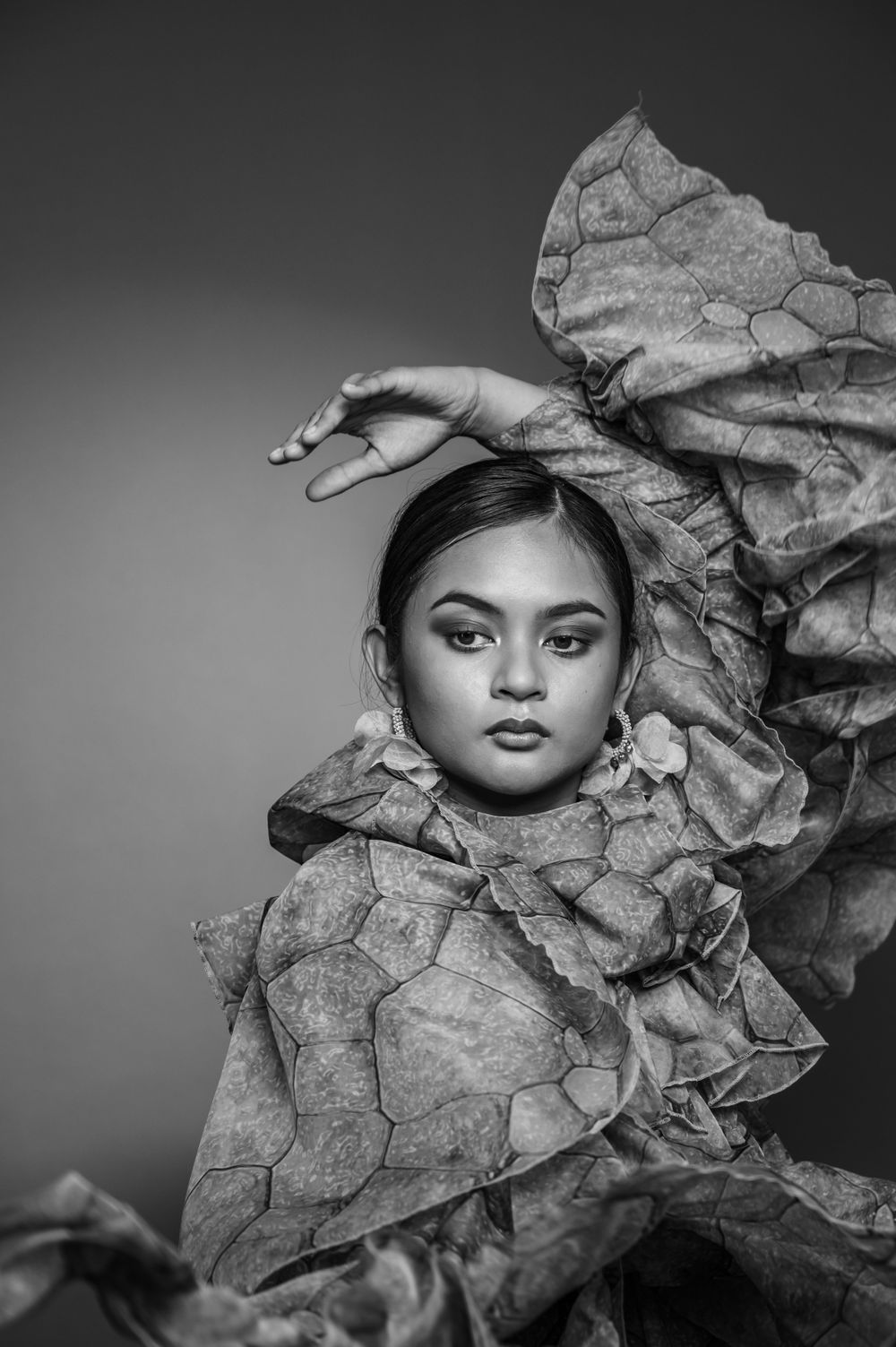 Dramatic black and white portrait with sculptural paper-like fabric wrapped around subject. SIX84 Photography, Portrait Photography, Sydney