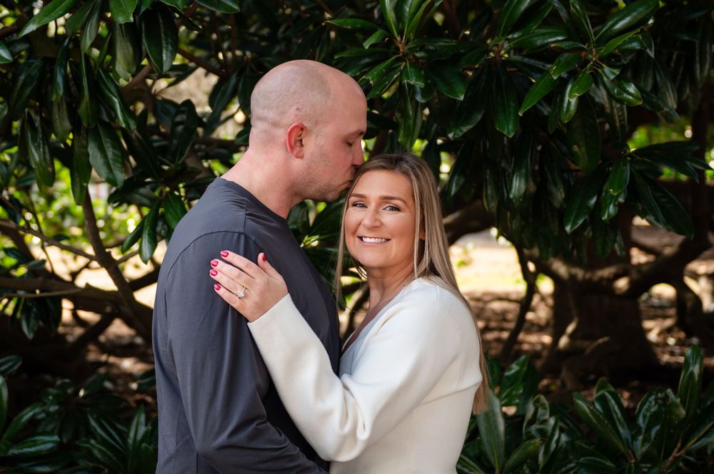 Intimate outdoor couple photography session against natural garden backdrop.