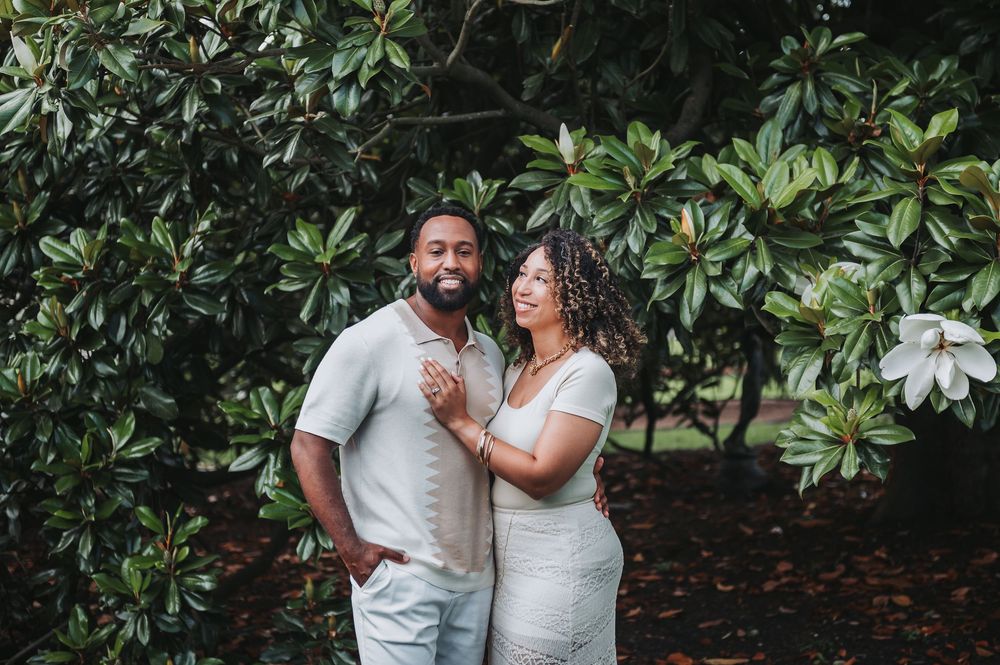 Romantic outdoor photoshoot with magnolia trees in the background.